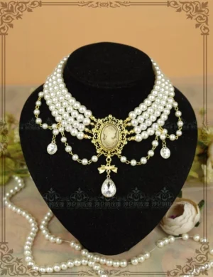 Classic white pearl tiered choker necklace with ornate gold cameo center pendant on black velvet jewelry mannequin display, showcasing front view of delicate Lolita jewelry with layered pearl strands and teardrop crystal accents