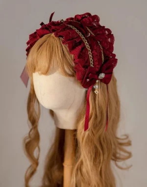 Wine red lolita ruffled lace headband with gold trim and dangling gem pendant displayed on mannequin, classic lolita hair accessory