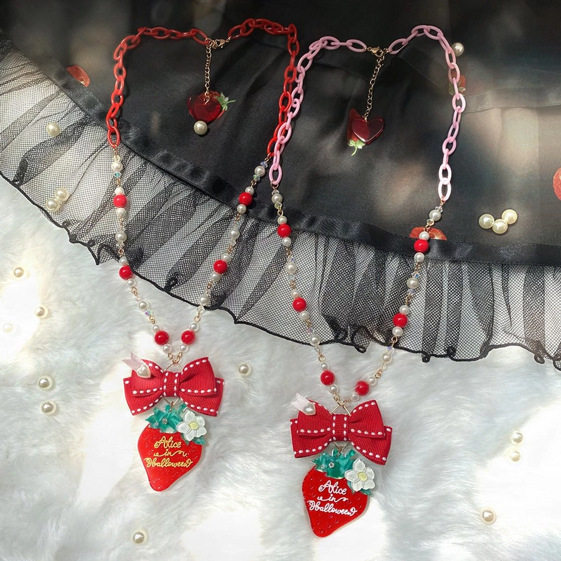 Classic pink strawberry lolita necklace accessory beaded chain bow detail close-up view