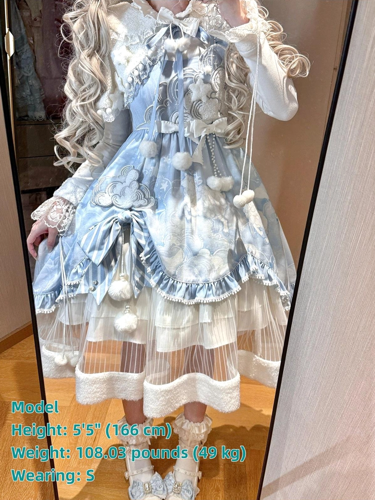 Side view of Cloudscape Dream sweet lolita JSK dress, displaying side profile, large satin waist bow, layered ruffled skirt silhouette, fuzzy fleece hem trim, lace-trimmed inner blouse sleeves