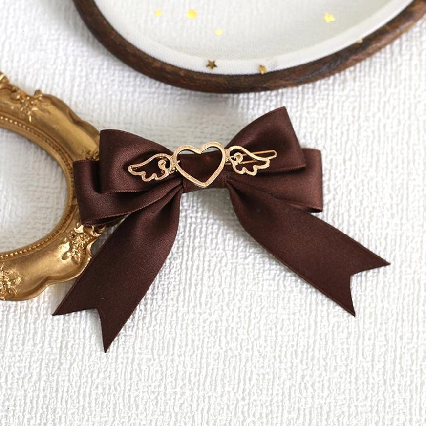 Single dark brown coffee satin lolita bow hair clip with smooth ribbon tails and gold heart-wing center charm