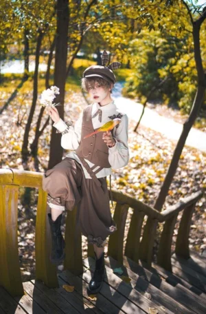 Ouji Lolita fashion model in coffee retro gentleman outfit posed from low angle on autumn forest wooden boardwalk holding small flower and toy bird with warm golden sunlight