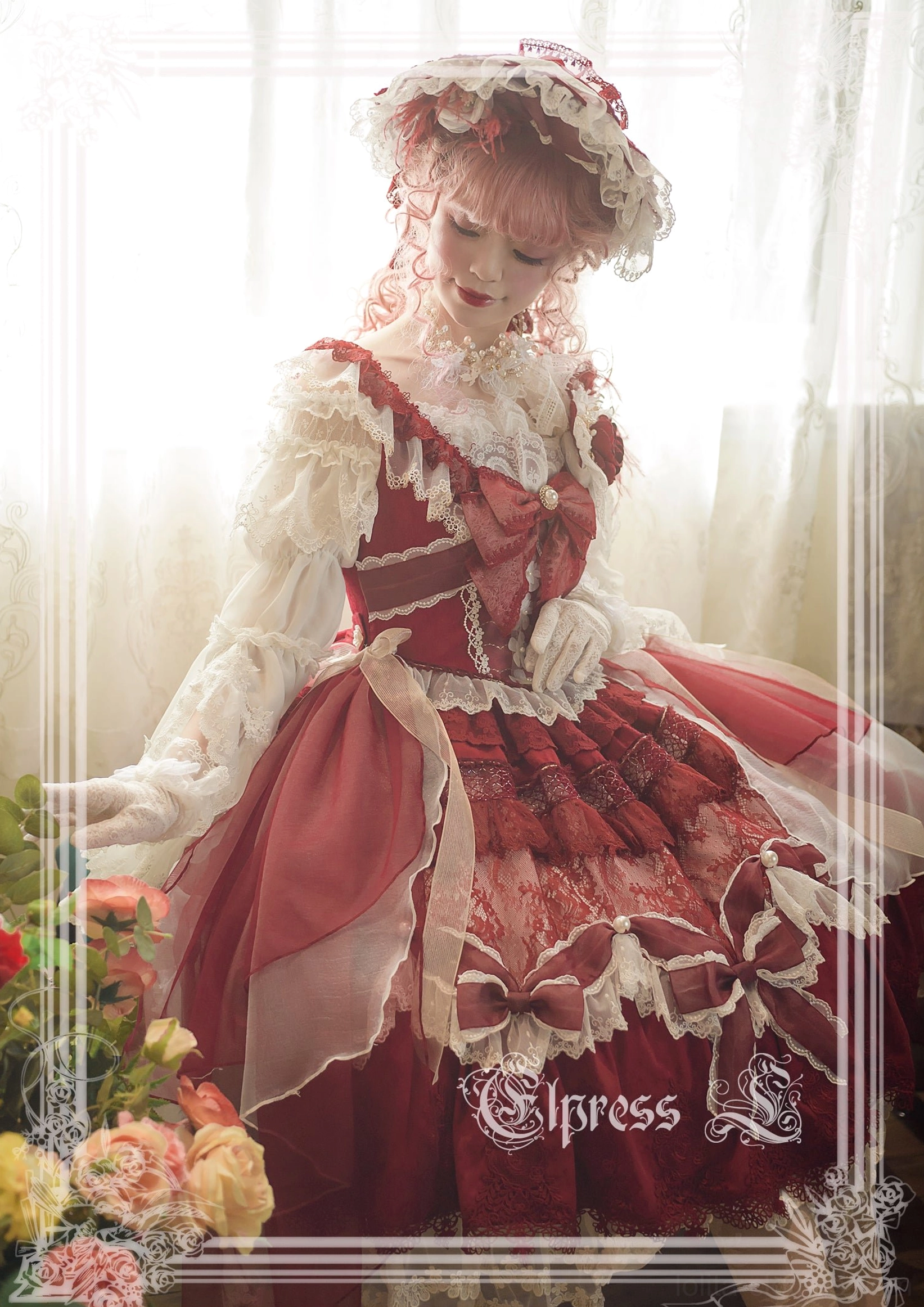 Complete burgundy red lolita coordinate on model wearing full dress with lace collar sleeves waist bow mesh veil bonnet pink curled hair styling
