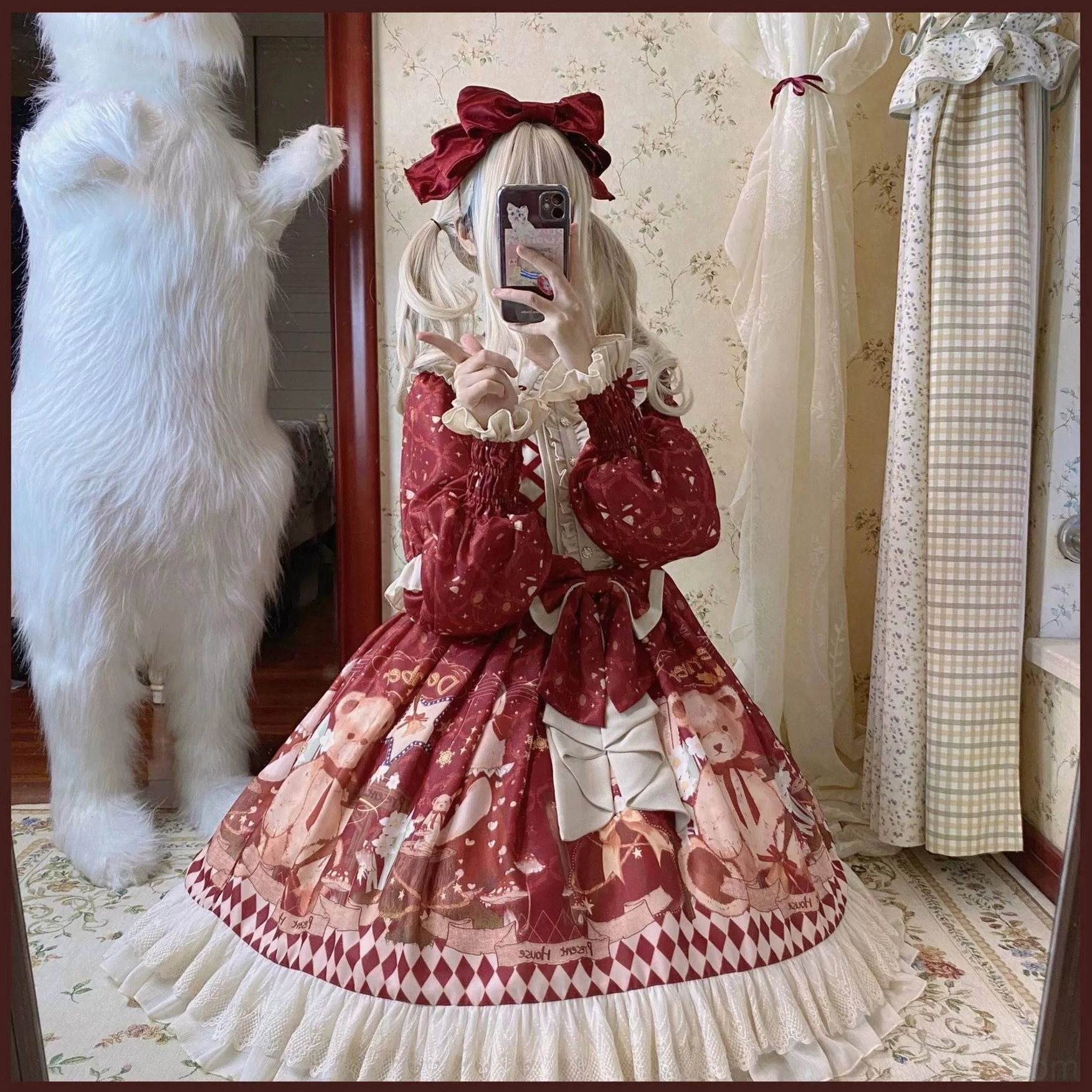 Full sweet lolita OP and cape ensemble front view on model with white plush fur trim bear ear hood and matching red ribbon bows wine red base color