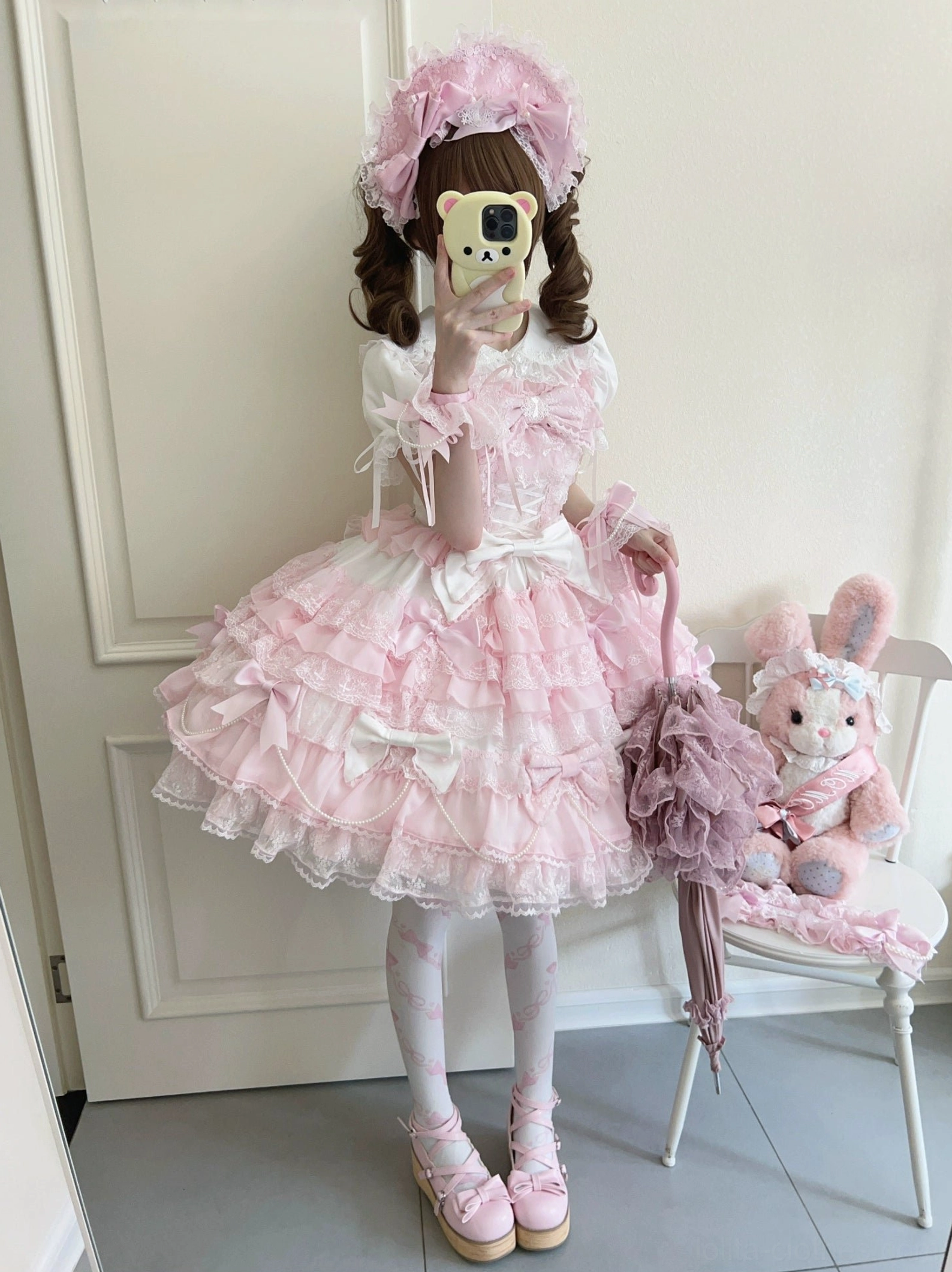Female model in complete lolita outfit set full-length mirror selfie with purple lace handbag headbow matching tights and platform shoes