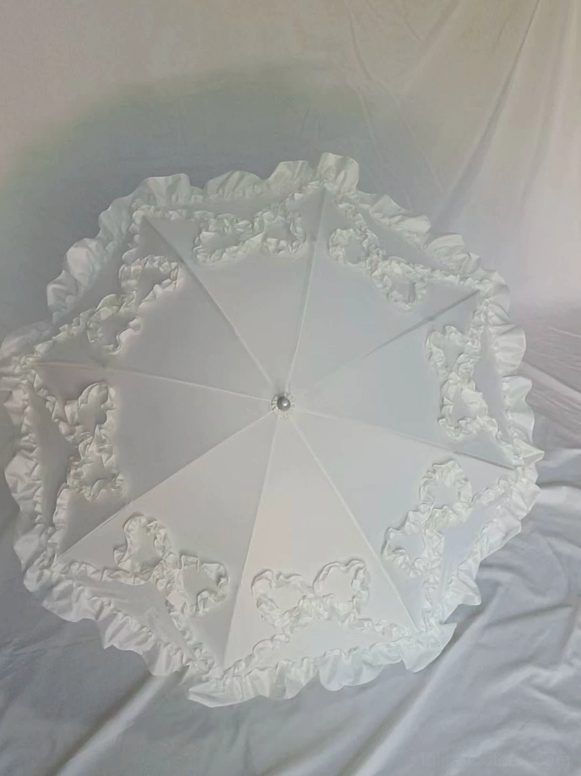 Complete foldable Lolita parasol collection featuring all six design styles and color variations arranged overhead, flat lay showcase of bow-ruffled heart-shaped bat-wing options