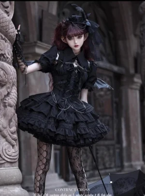 Contract Cross black gothic lolita jumper skirt dress with cross metal chest ornament and tiered ruffled skirt three quarter side view outdoor European architecture