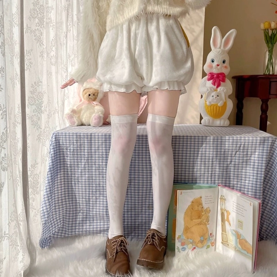 Front partial standing view of white velvet corgi-themed Lolita bloomers showing clean puff balloon silhouette and professionally finished ruffled leg hem