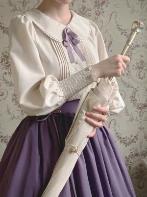 Vintage lolita blouse and high-waisted skirt close-up detail shot showing bishop sleeves lace trim and bow with vintage accessories