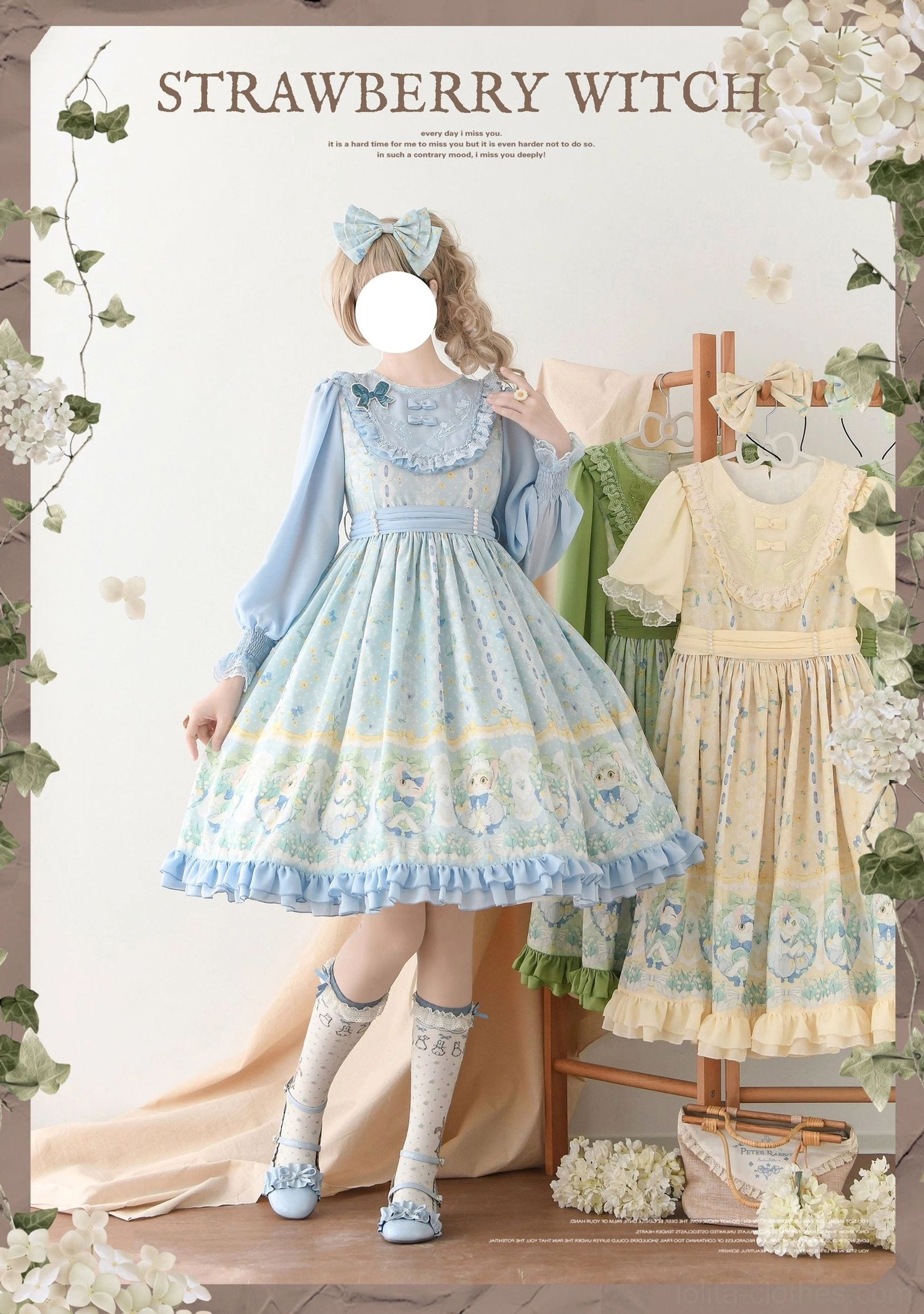 Blue long-sleeve country lolita OP dress with cat and floral prints, front full-body shot on model with blue bow and printed socks in floral backdrop setting