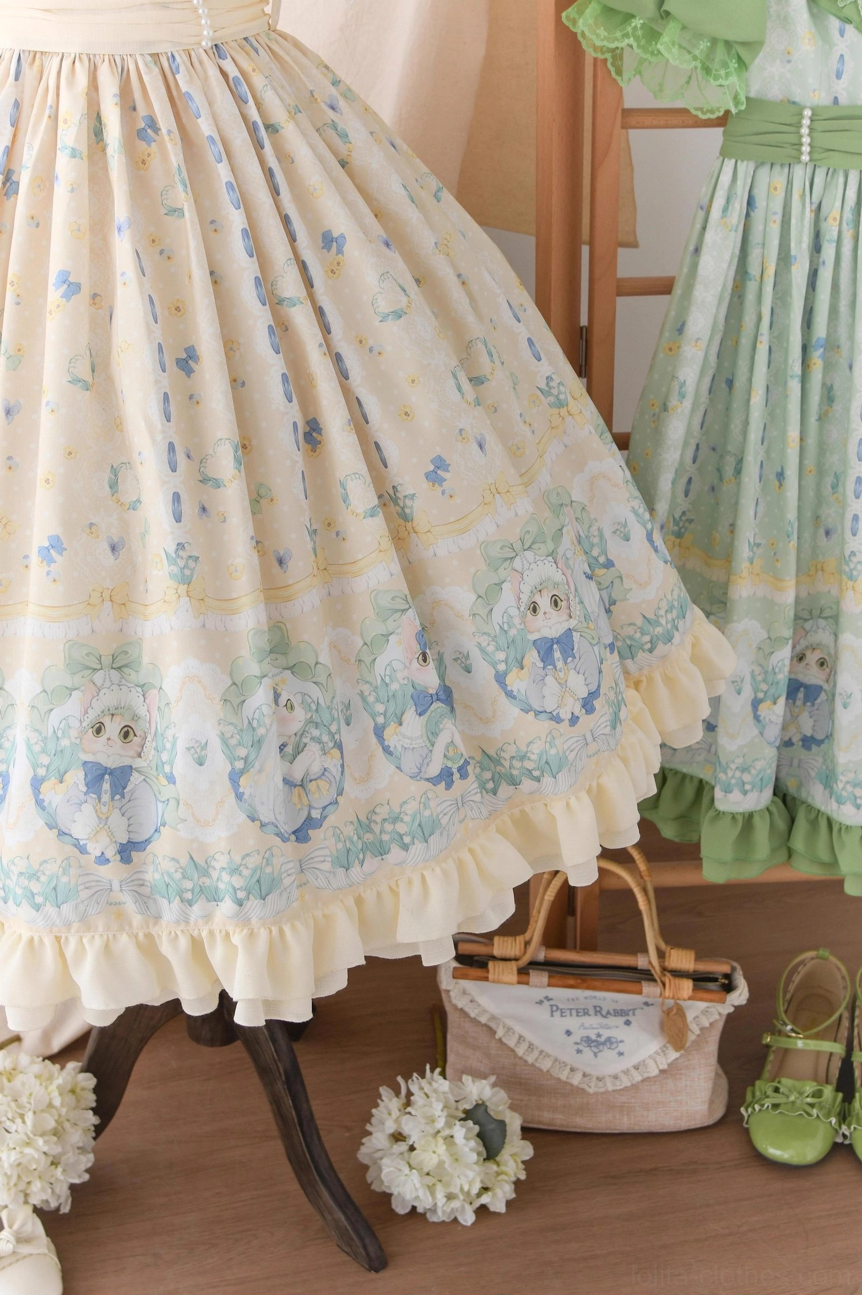 Country lolita OP dress blue long-sleeve variant front view on model showing full ensemble with matched lolita accessories and floral backdrop photography
