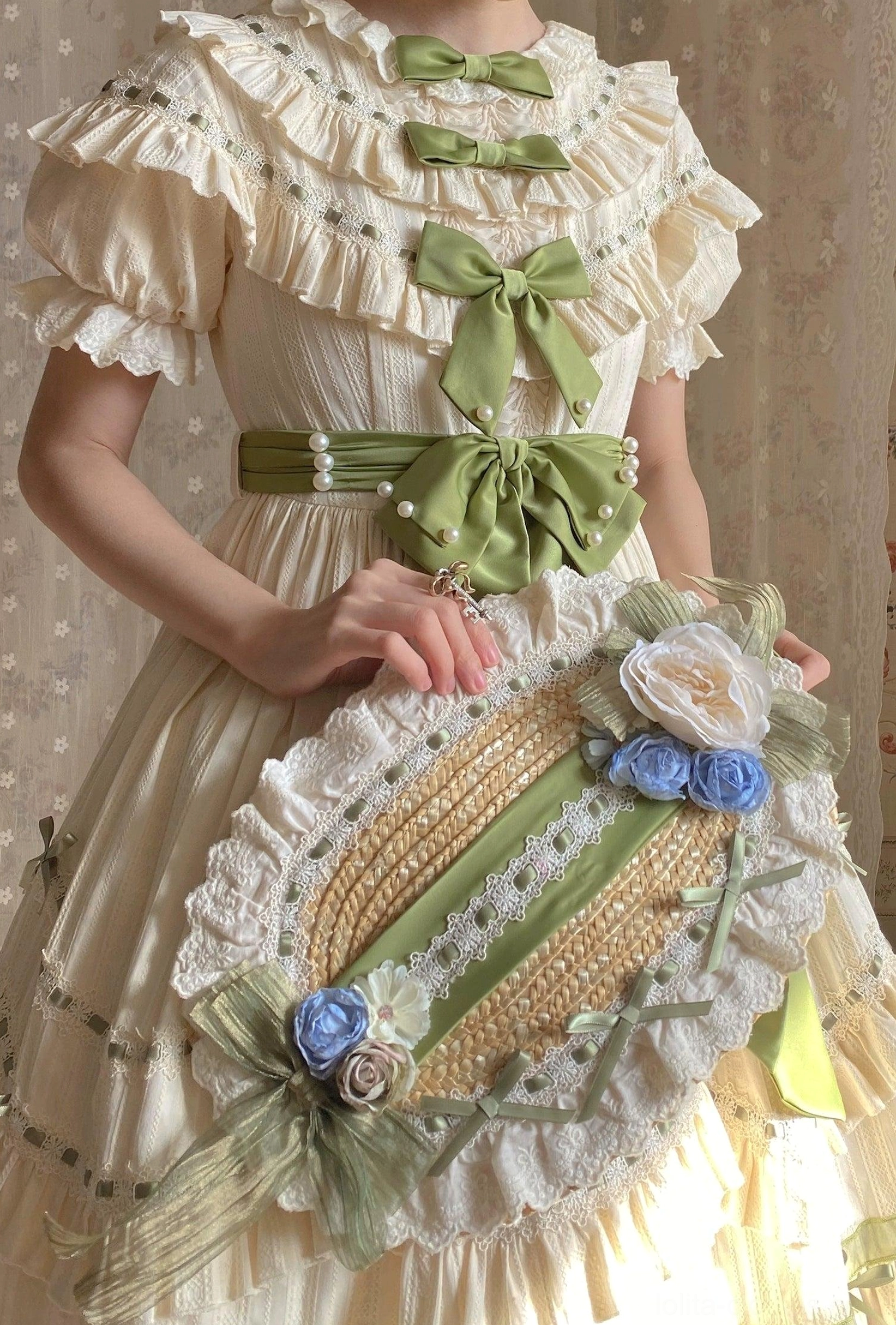 Lily of the valley country lolita OP dress featuring tiered ruffles, sage green ribbon accents, puff sleeves, and botanical-inspired design detail