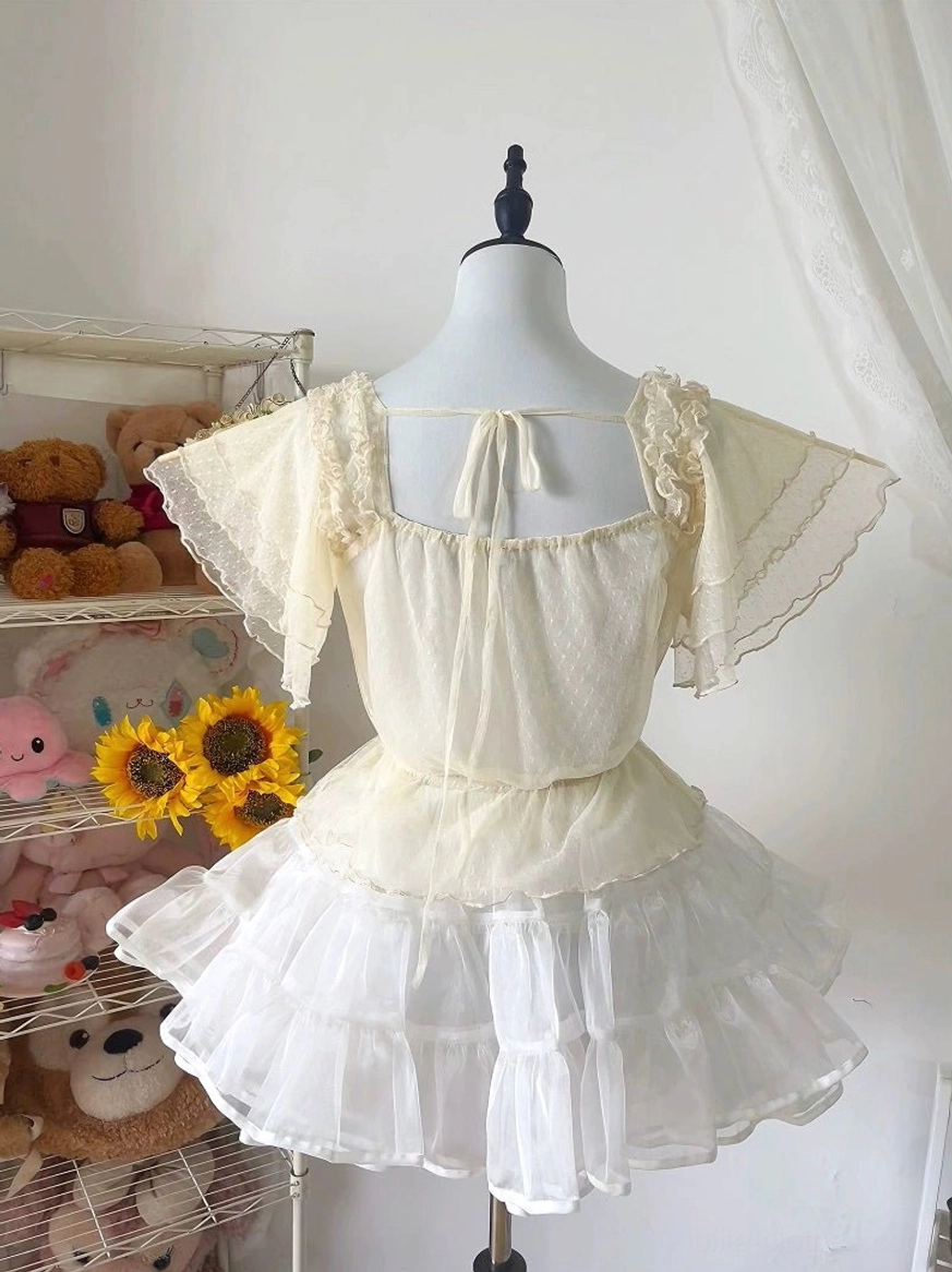 Cream beige Lolita blouse with lace-trimmed flutter sleeves and tie-back neckline, back three-quarter view on mannequin