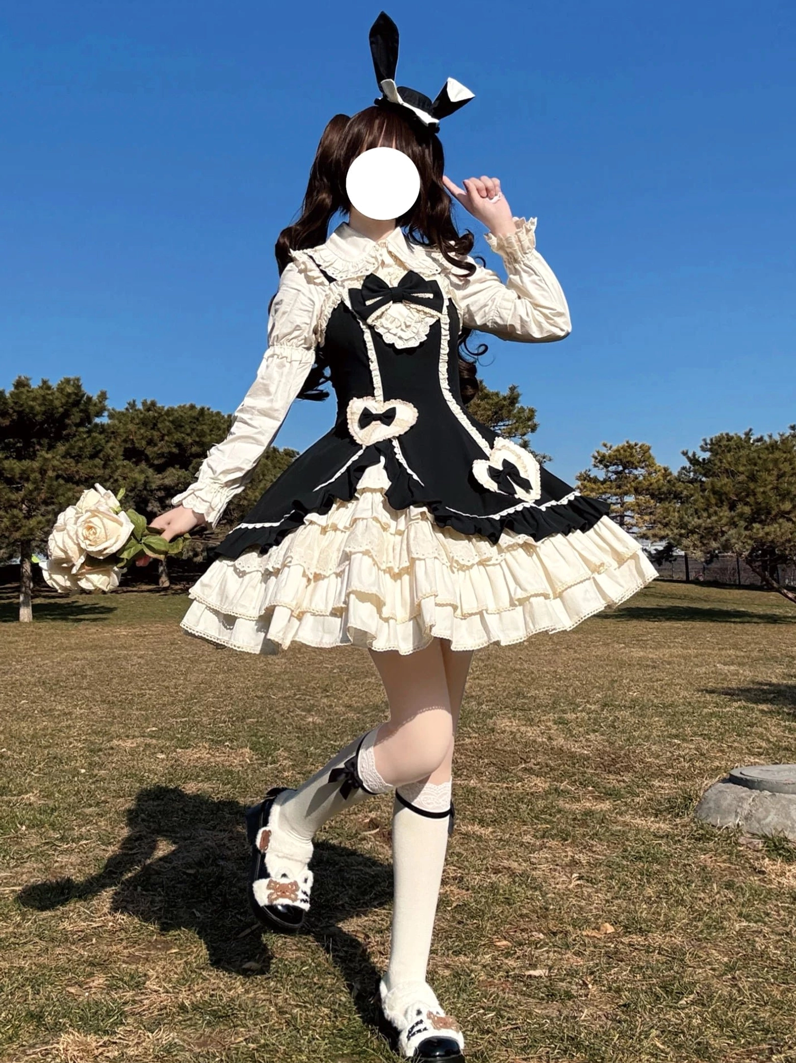Cream Bud tiered ruffle old school lolita JSK black white front three-quarter dynamic outdoor pose showing side opening and tiered hem detail