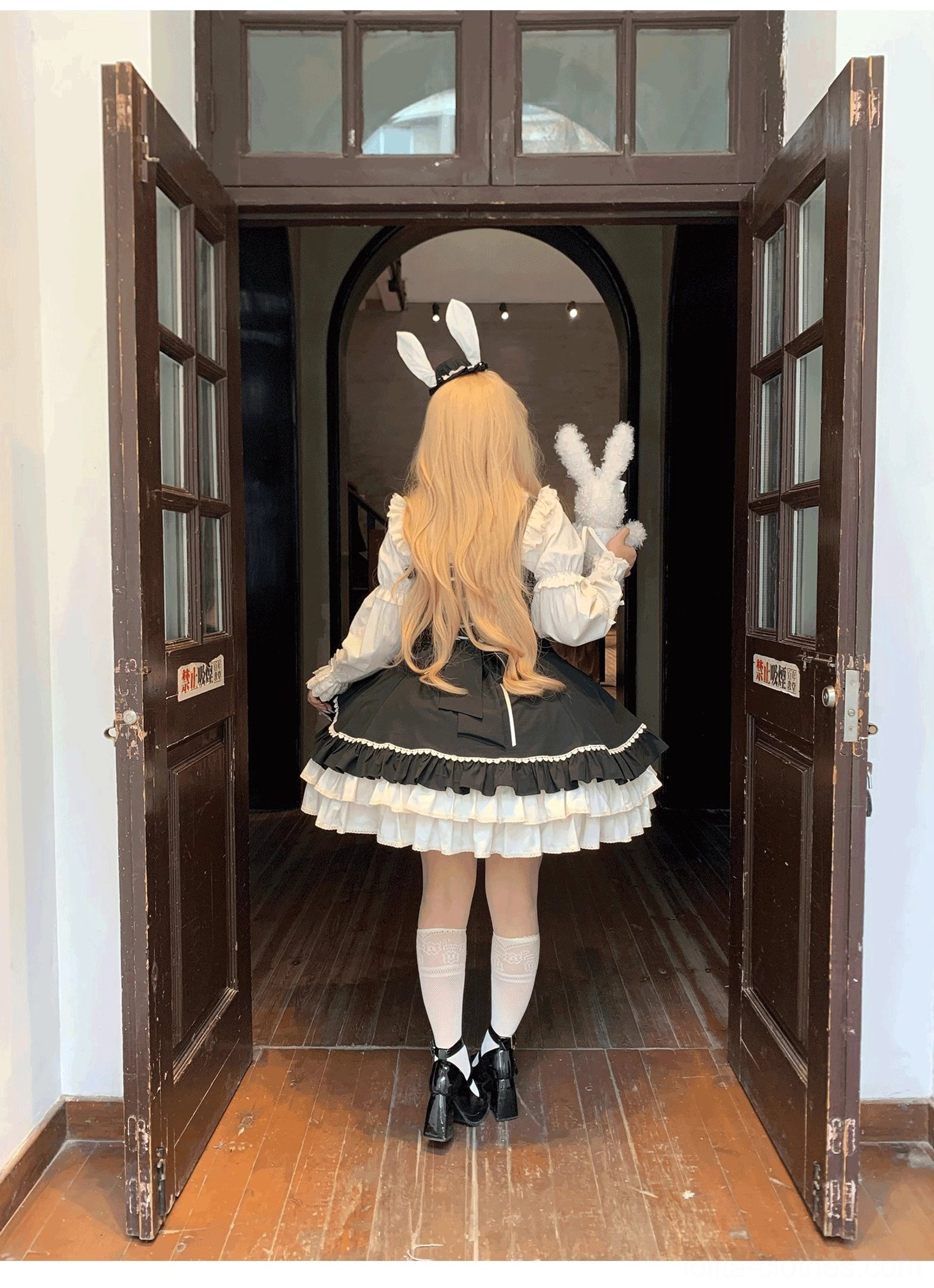 Cream Bud tiered hem lolita JSK black colorway back full view indoor vintage doorway interior layered ruffles Mary Jane shoes