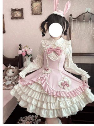 Cream Bud tiered hem old school lolita JSK pink colorway full front close-up with large front bow and heart trims vintage bedroom setting