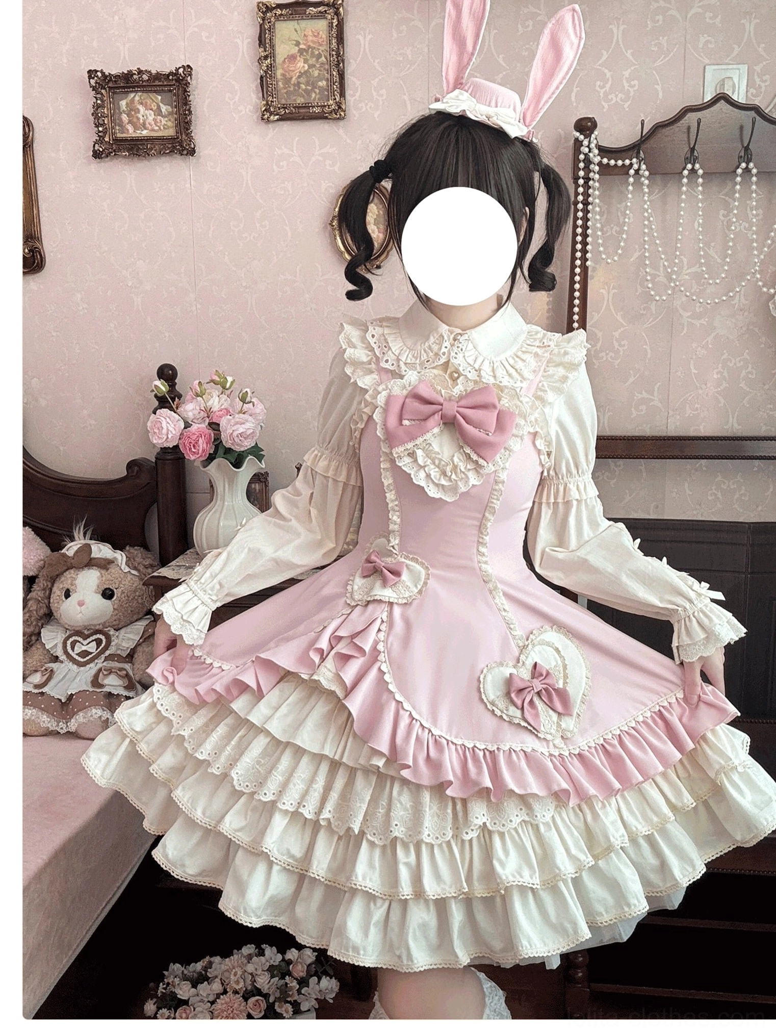 Cream Bud tiered hem old school lolita JSK pink colorway full front close-up with large front bow and heart trims vintage bedroom setting