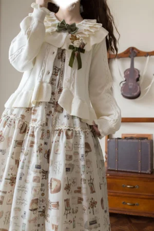 off-white cream lolita knit cardigan back three-quarter view with beige vintage pattern long dress and violin shelf backdrop