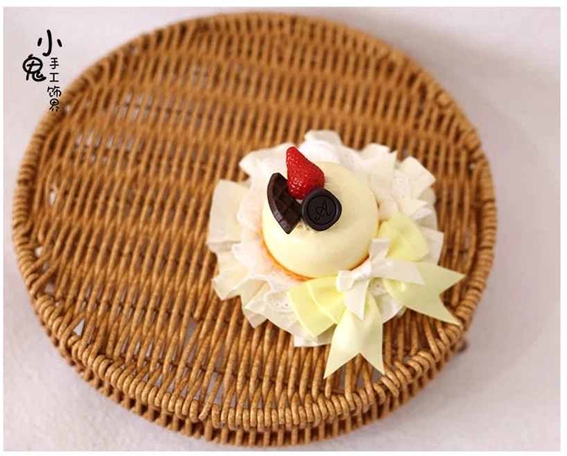Mini cream dessert Lolita hairpin overhead flat lay featuring pale yellow base with strawberry and chocolate charms light yellow satin bows and delicate lace details