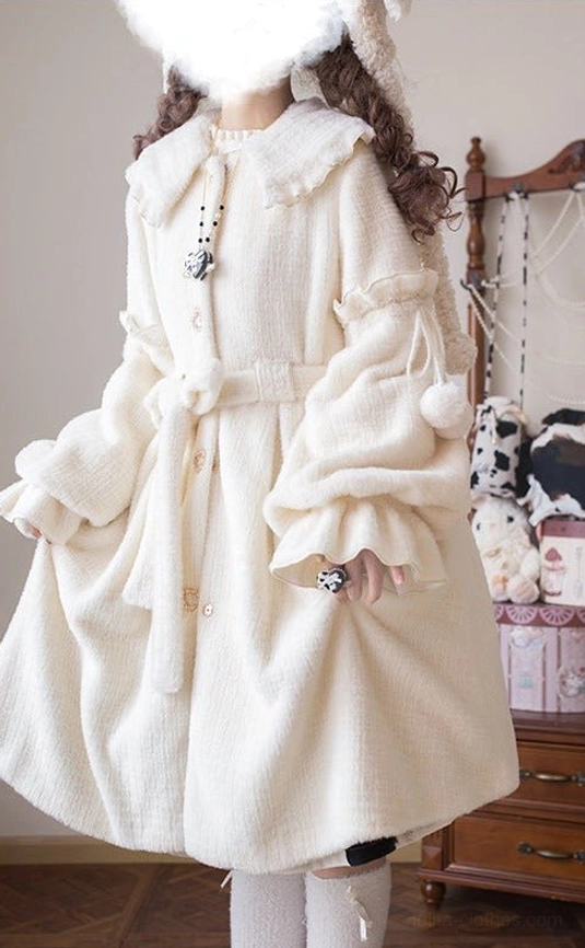 Winter lolita coat detail shot showing bishop sleeve with fuzzy ball trims, belted waist, and decorative collar brooch in vintage bedroom aesthetic
