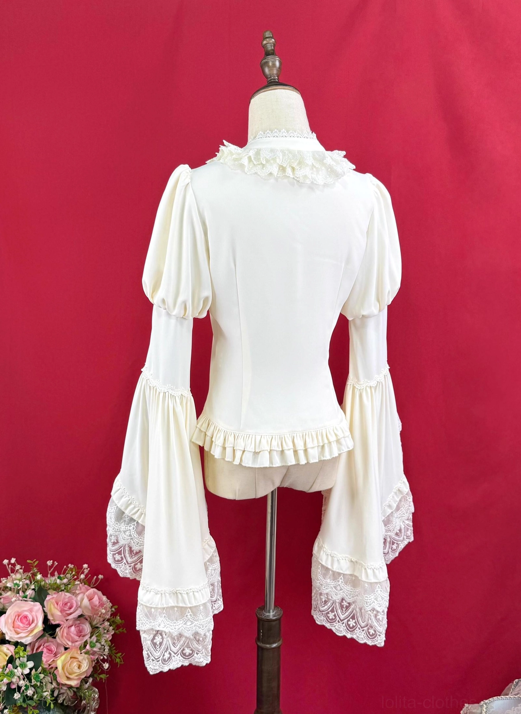 Back view of cream white Lolita blouse showing ruffled stand collar fitted silhouette lace-trimmed trumpet sleeves and ruffled waist hem