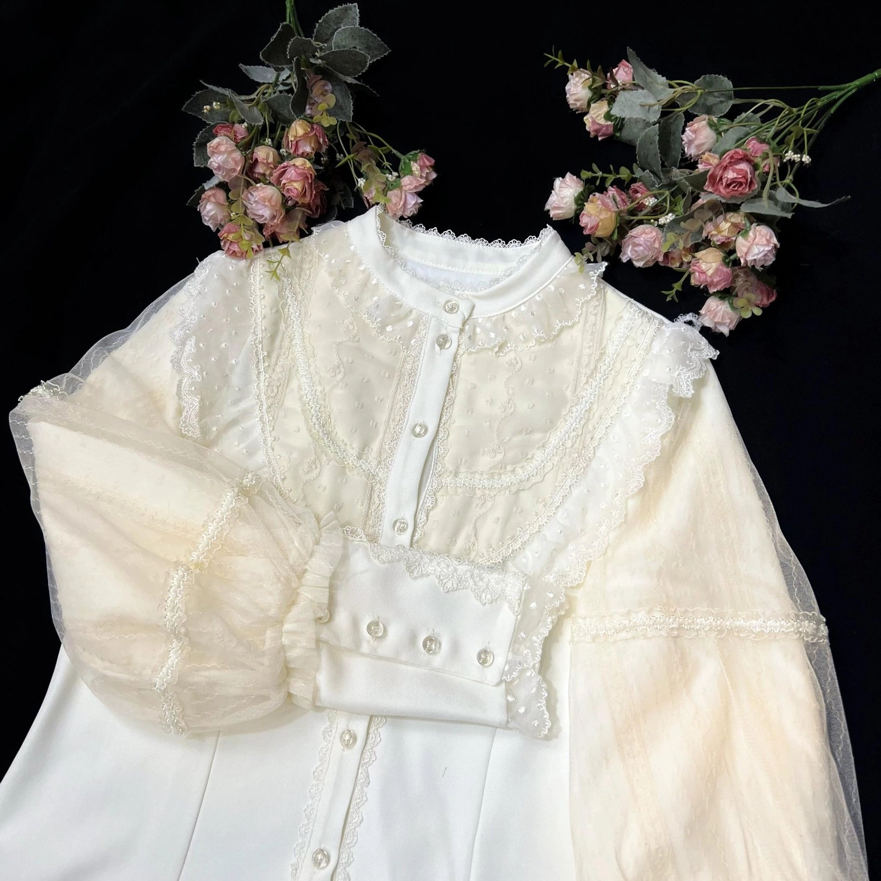 Cream Lolita blouse with embroidered lace front panel, voluminous sheer lantern sleeves trimmed with ornate lace cuffs, ruffled stand collar, and front button closure exemplifying authentic Japanese Lolita fashion aesthetic and elegance