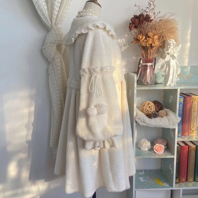Full side hanging display of cream puff lolita winter coat with ruffled Peter Pan collar, drawstring plush pocket featuring pom-poms, tiered ruffled hem, and fuzzy woven fabric