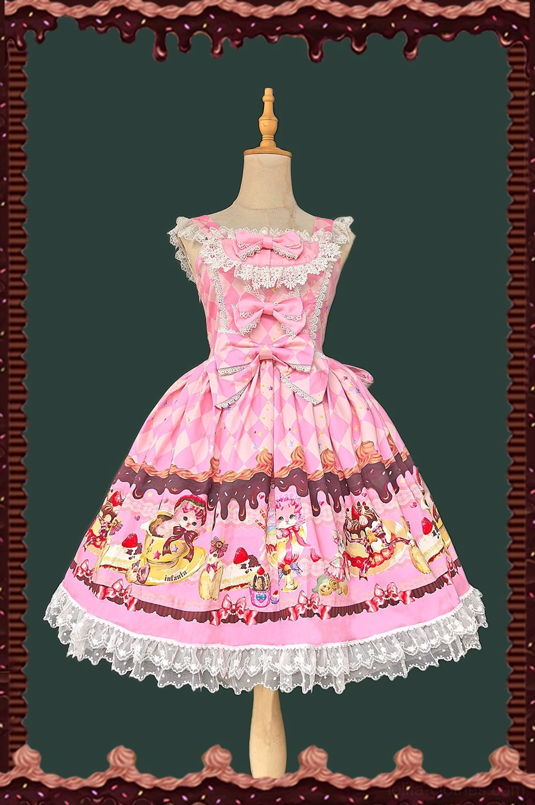 Pink sweet lolita jumper skirt with cat and dessert print, front view showing lace-trimmed neckline, prominent front bow, and argyle pattern bodice