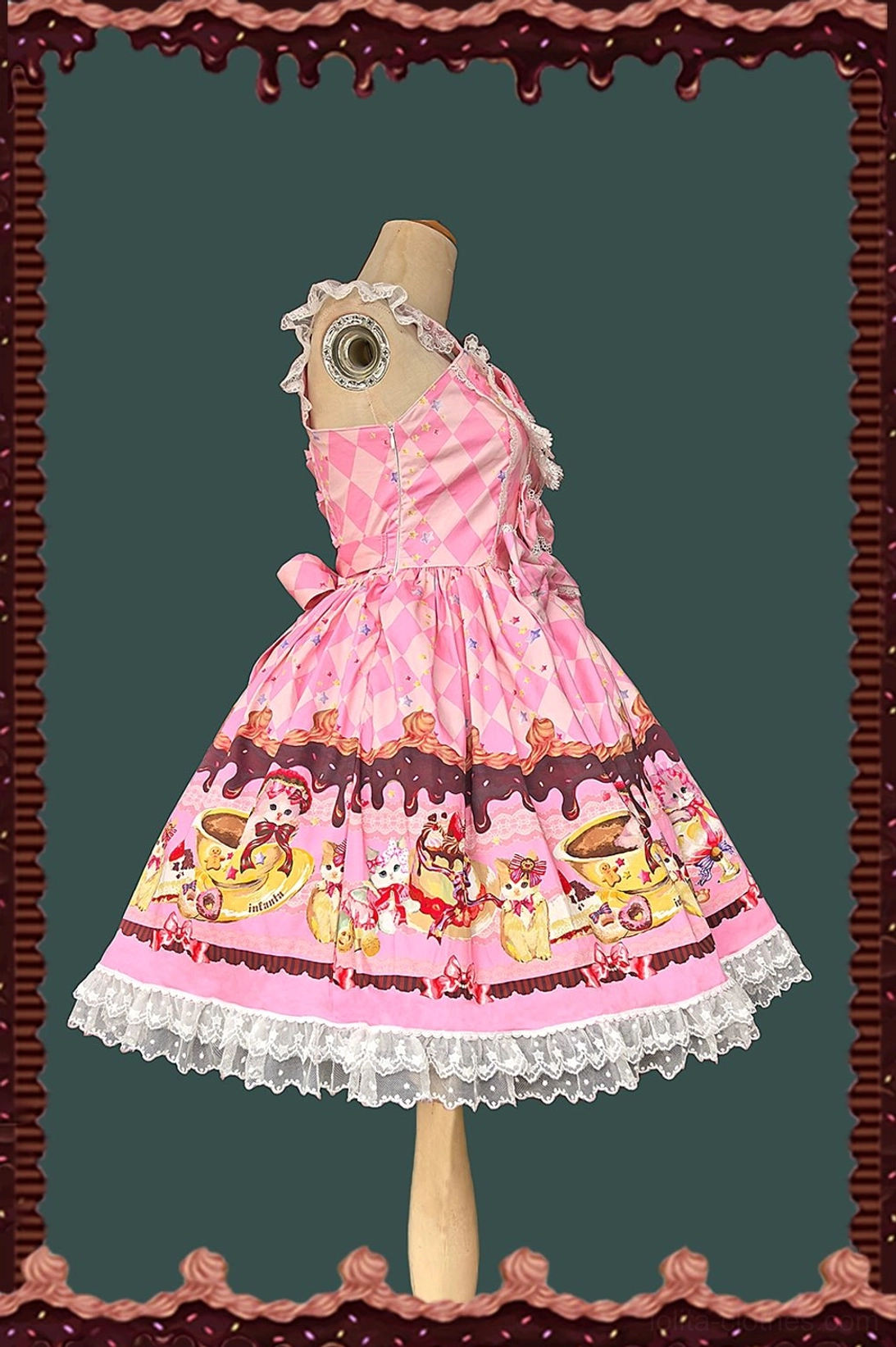 Pink sweet lolita jumper skirt side view displaying one-shoulder lace strap, small side bow, argyle bodice pattern, and matching cat print hem