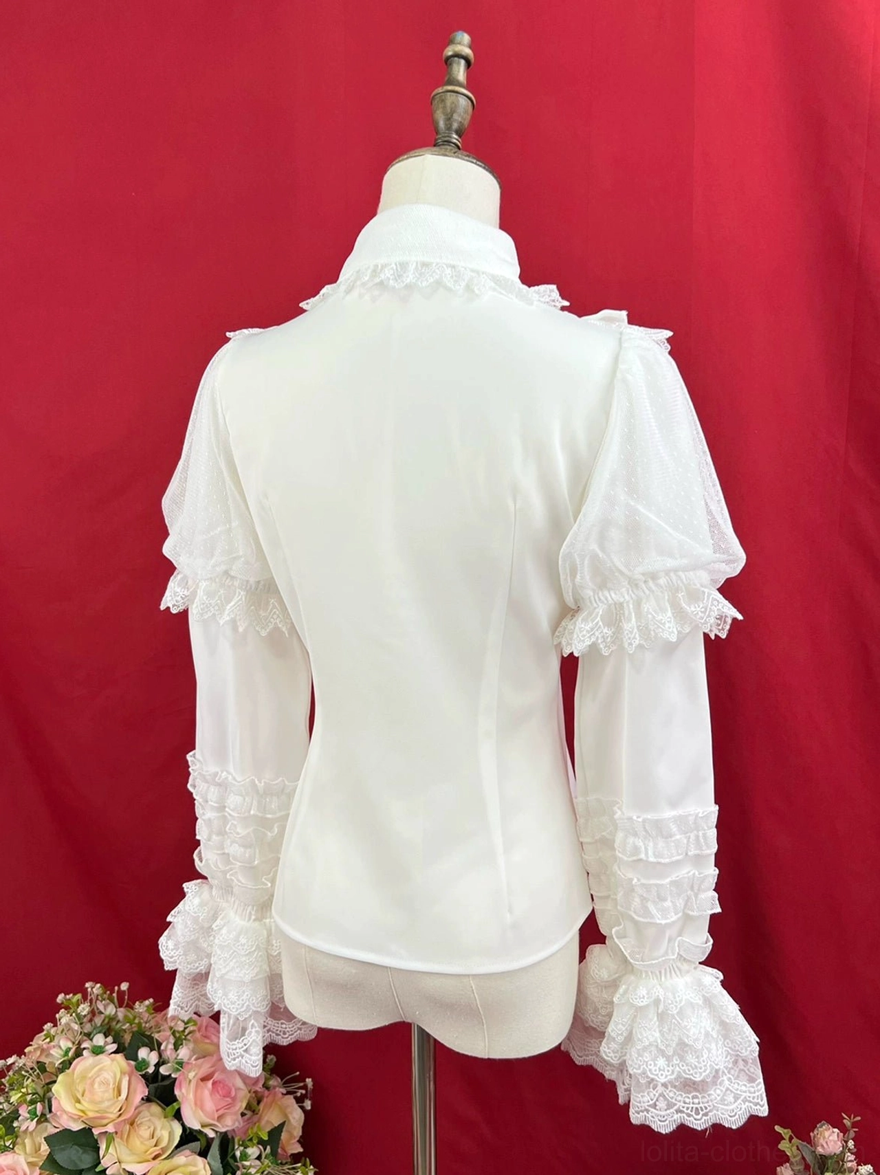 Off-white cream sweet lolita long sleeve blouse back view on dress form showing exposed back seam layered ruffled long sleeves lace flared cuffs red studio backdrop