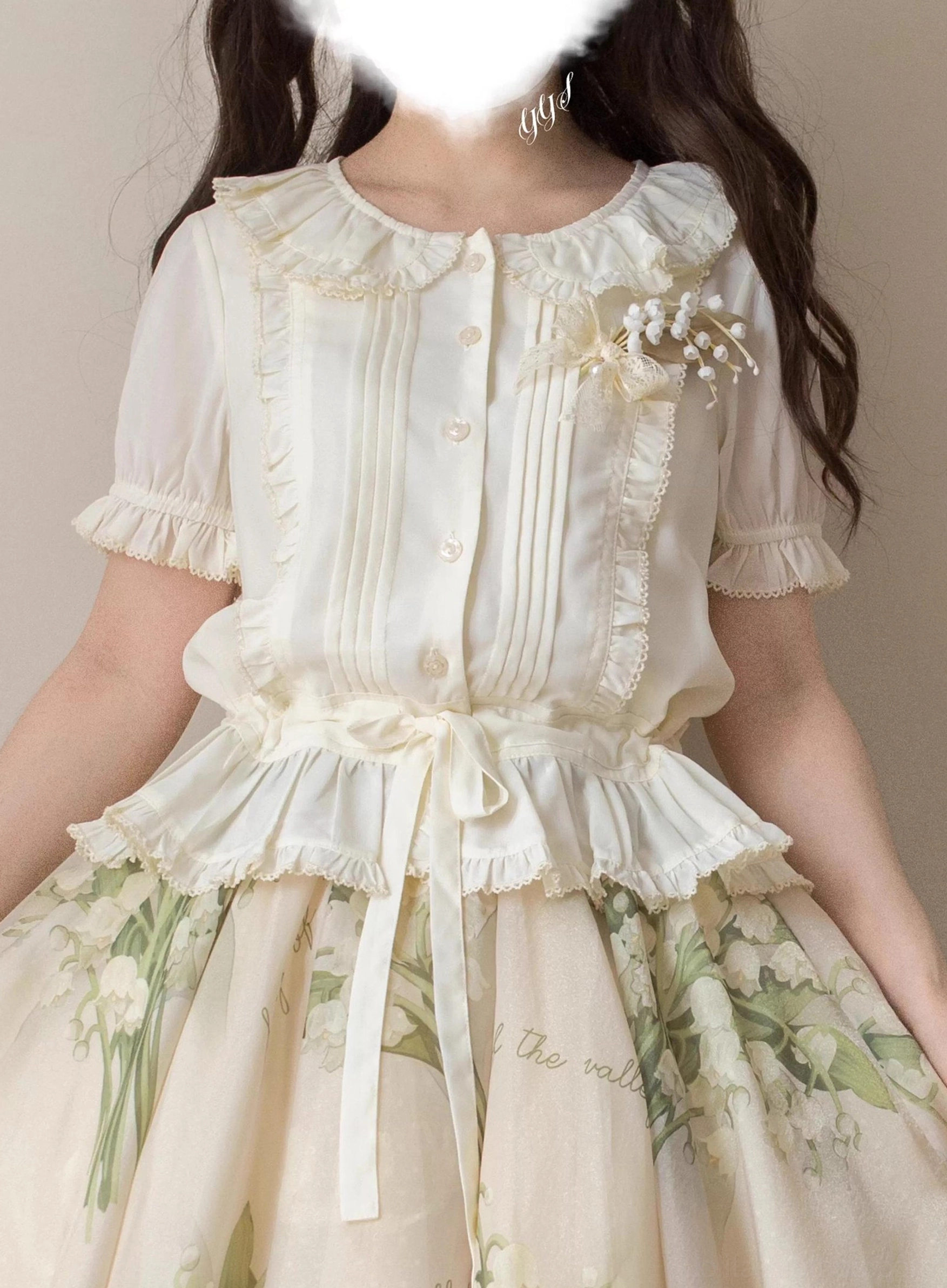 Cream colored sweet Lolita blouse styled with lily-of-the-valley printed skirt, featuring ruffled round collar, front pintuck panels, and decorative brooch accent