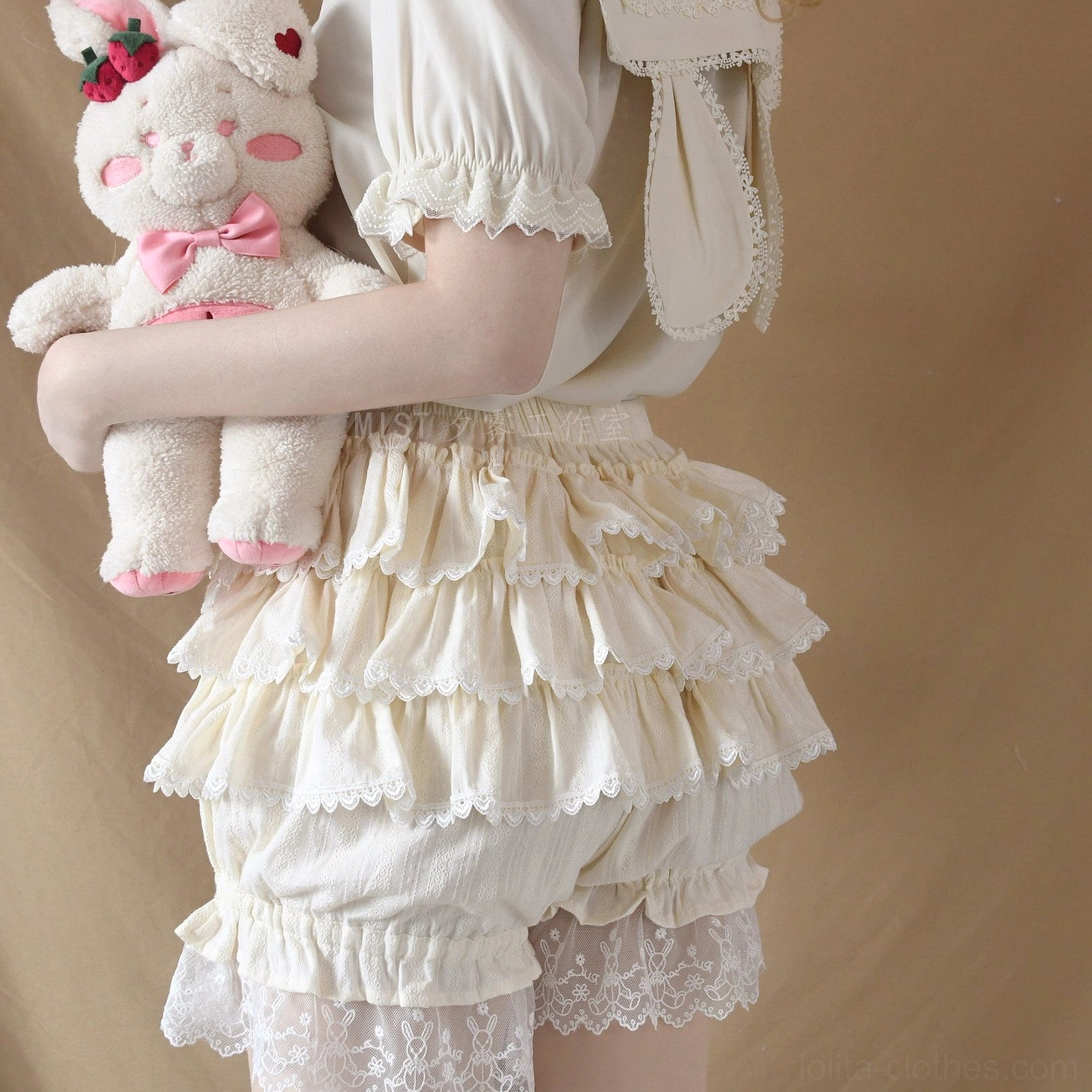 Cream-colored sweet lolita pumpkin bloomer shorts with multi-layered ruffles and lace hem detail, showcasing elastic waistband and feminine aesthetic from side close-up perspective