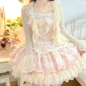 Cream-colored tulle lolita bolero with ruffle lace collar and satin bow detail, worn by model with pink corset dress set in vintage vanity bedroom setting