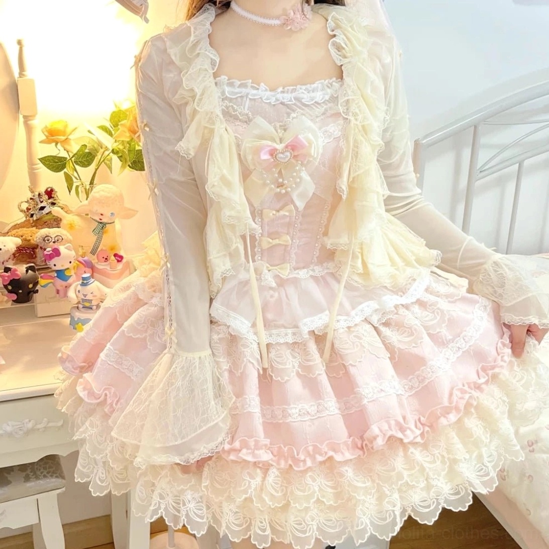 Cream-colored tulle lolita bolero with ruffle lace collar and satin bow detail, worn by model with pink corset dress set in vintage vanity bedroom setting