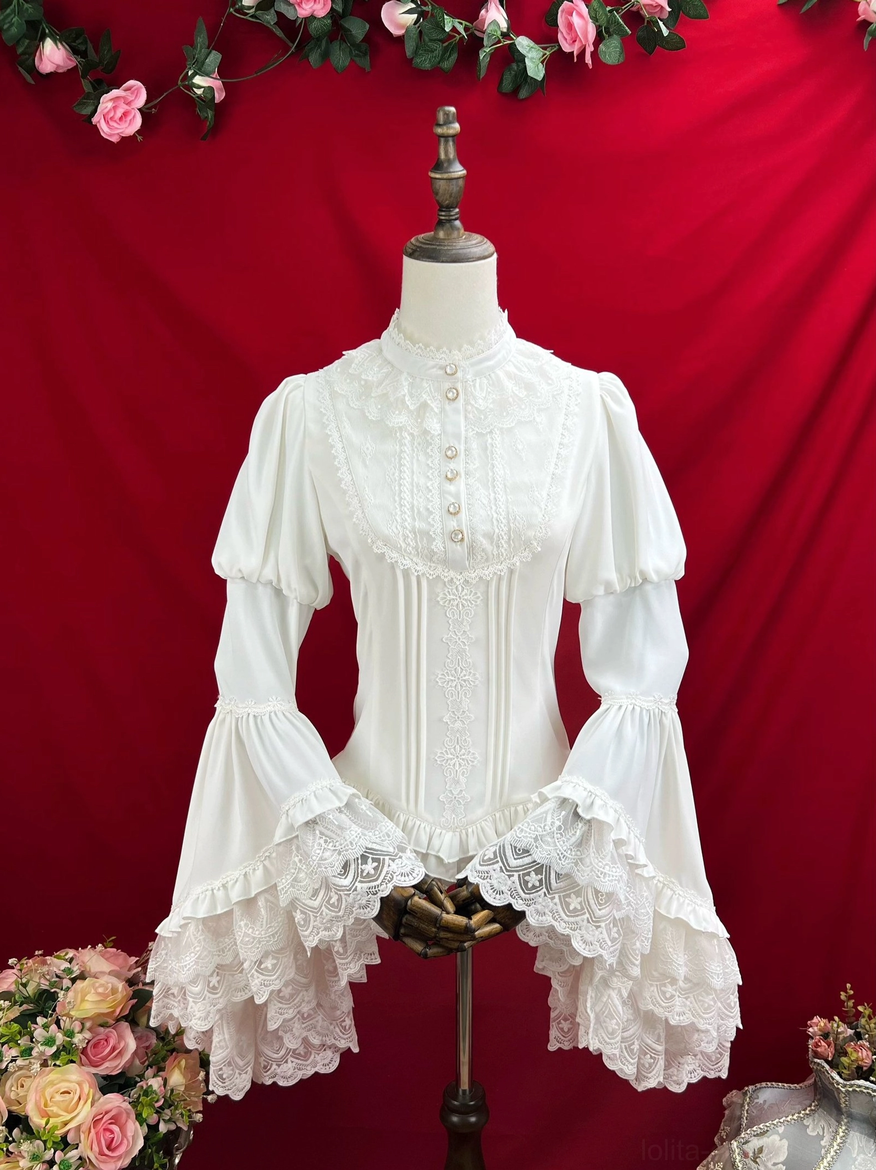 Cream white vintage Lolita blouse with stand collar front lace panel decorative buttons and layered lace trumpet sleeves front view