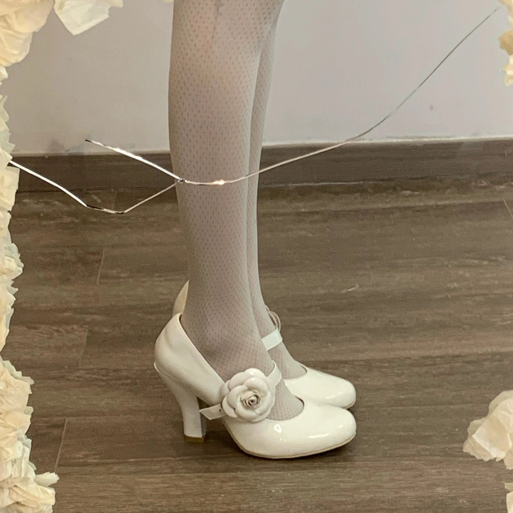 Cream white Lolita Mary Jane high heel shoes overhead flat lay of wearing feet wooden floor ruffled fabric frame patent leather white rose ankle strap sheer tights