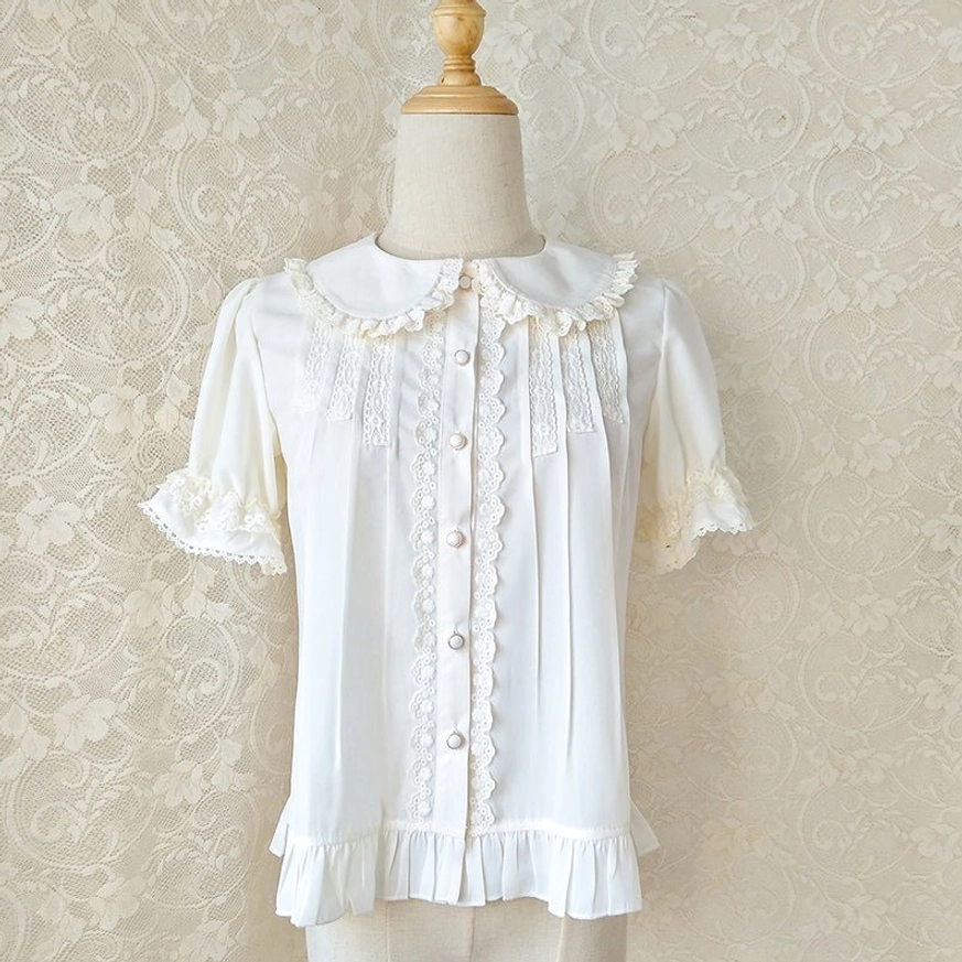 Cream white Peter Pan collar lolita blouse with ruffled lace cuffs and collar trim front-facing on dress form displaying delicate feminine details