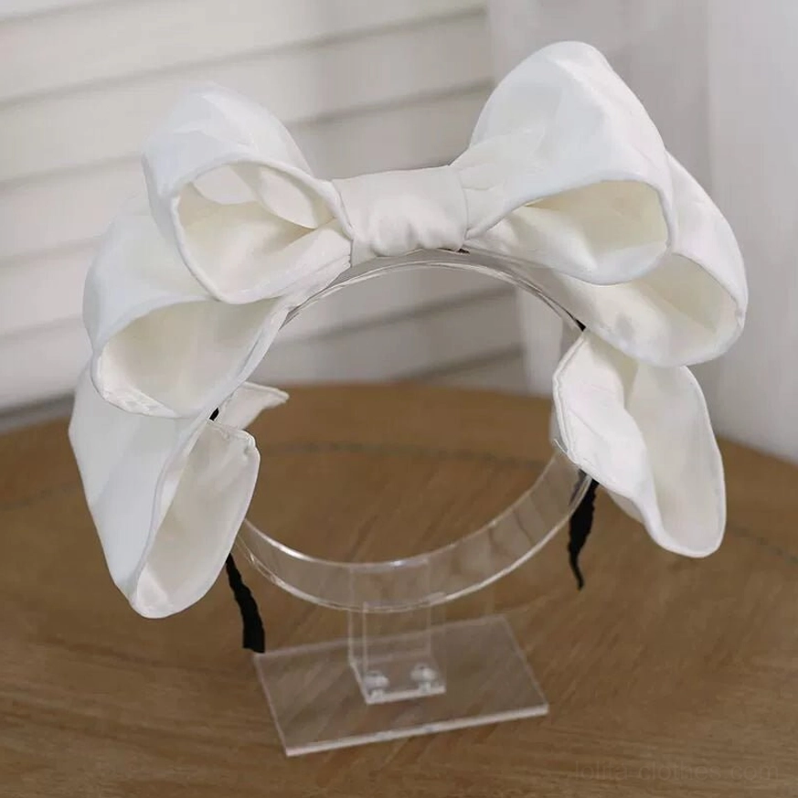 Pure cream white oversized satin bow Lolita hair clip on clear acrylic stand side view soft satin texture layered voluminous bow design