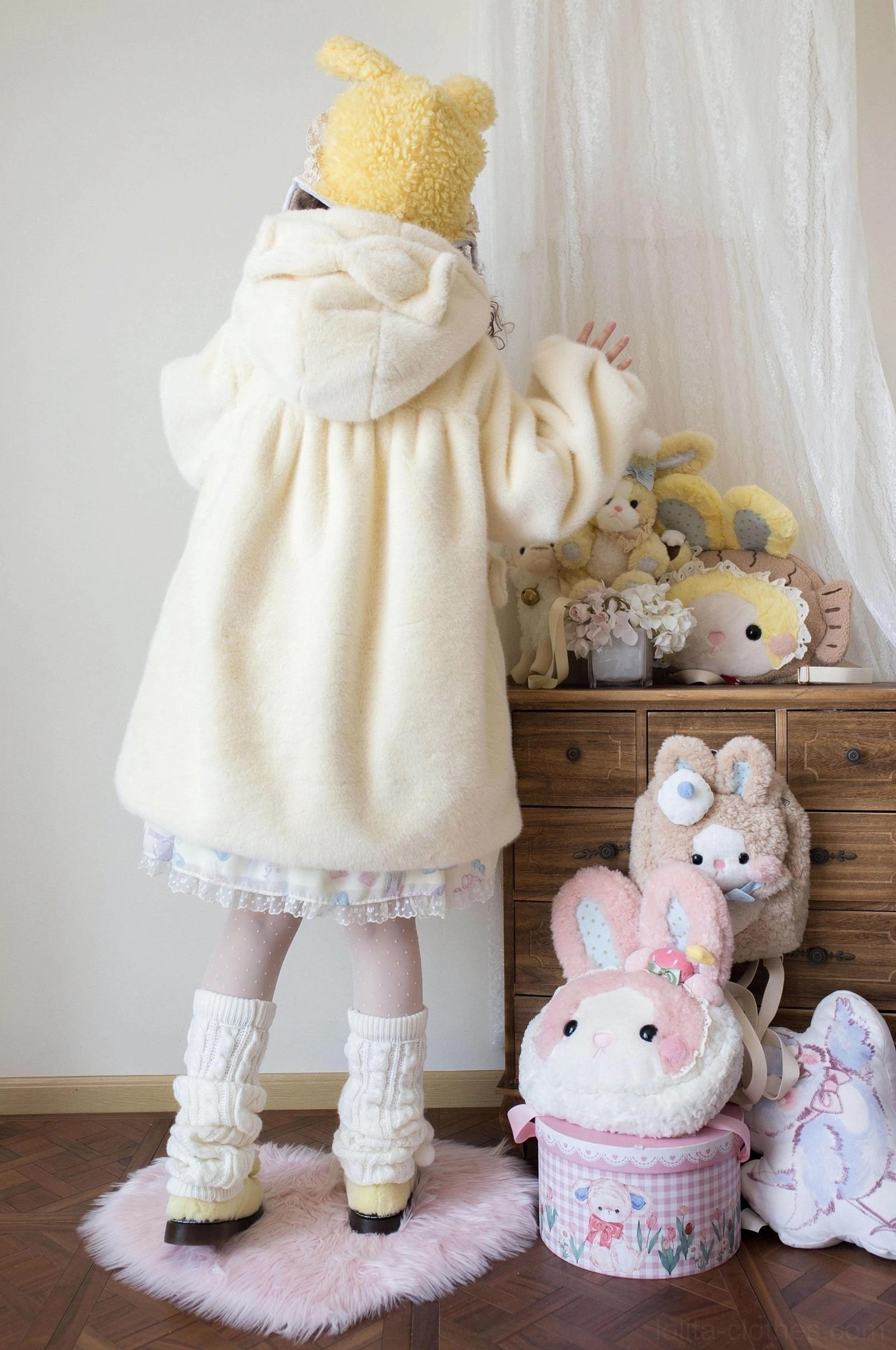 Cream yellow lolita winter thickened fluffy overcoat back view showing bear ear hood, ruffled hem detail and fuzzy fleece texture with bunny ear hat