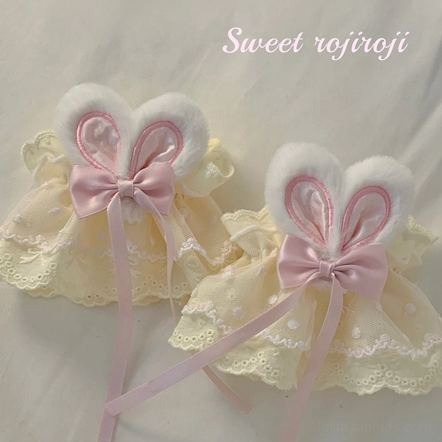 Cream yellow rabbit ear lace hand sleeves white fluffy ears pink satin bow hollow lace trim flat lay detail