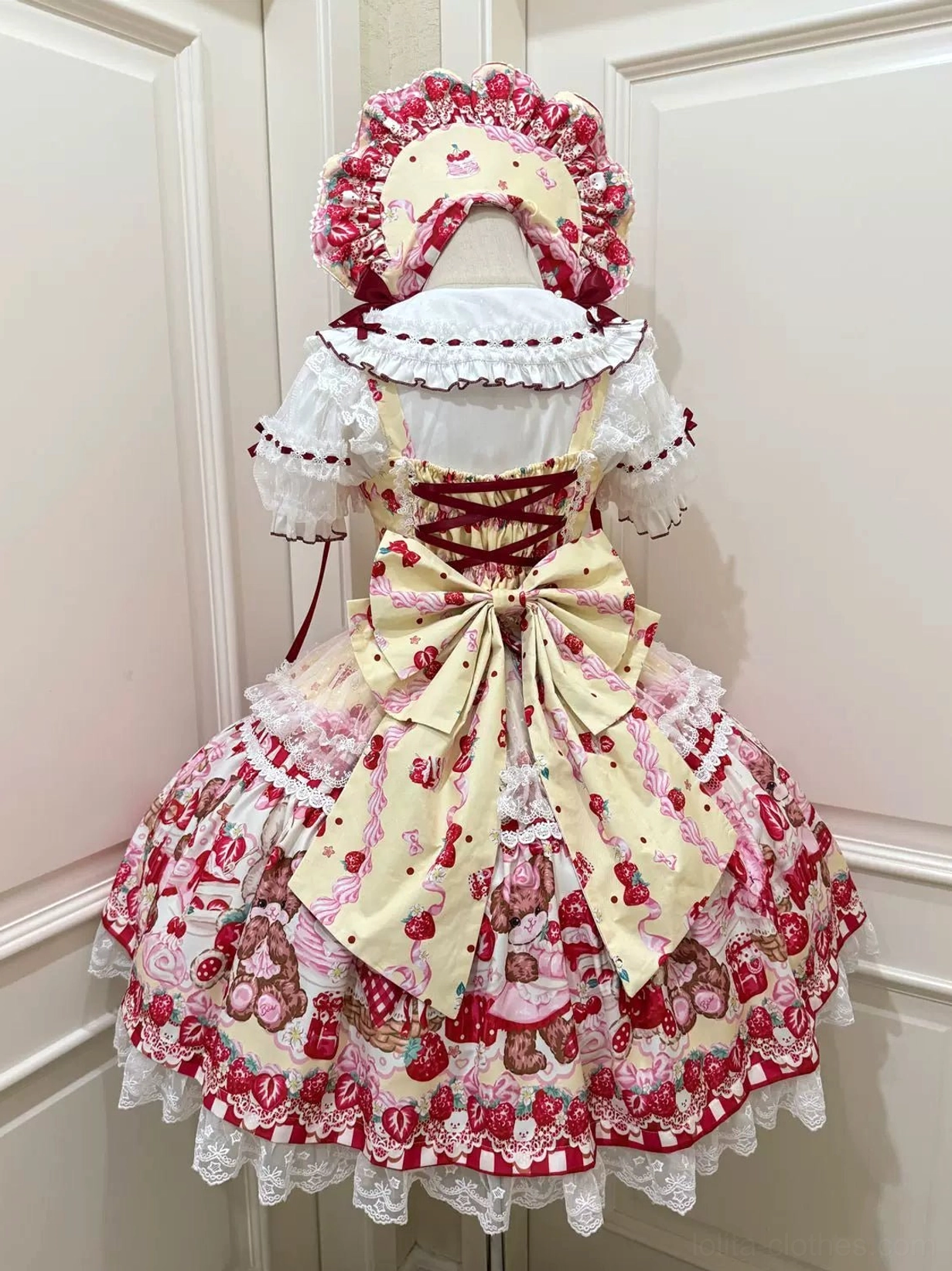 Cream yellow sweet lolita strawberry print JSK dress back view with beige trailing bow and white ruffled sleeves