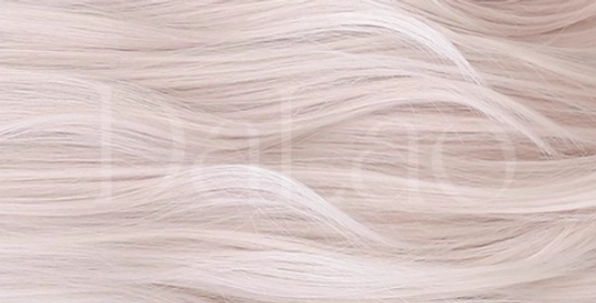 Close-up macro shot of creamy pink lolita wig hair strands showing natural loose wavy texture, soft smooth finish, and light blonde pink color quality