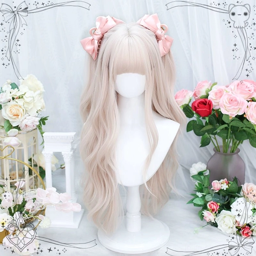 Soft creamy pink long curly lolita wig with light air bangs on mannequin display, front view with pink satin bows against white floral background