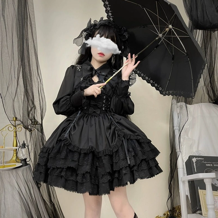 Side view of Black Cross Medal Gothic Lolita dress with matching bolero, lace-edged parasol, gothic headdress, lace-up waist detail, and ruffled layered hem in dark studio