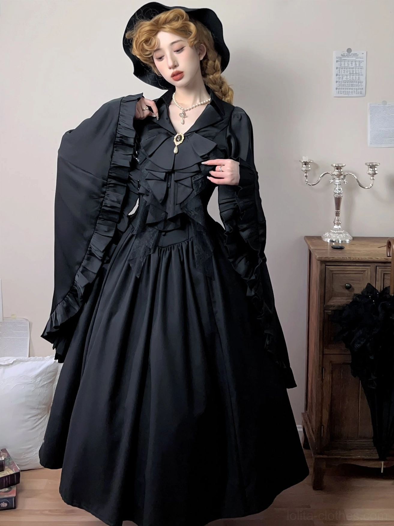 Side-front view of a Gothic Lolita outfit styled with the black detachable ruffle jabot, vintage black long-sleeve dress, and Gothic hat