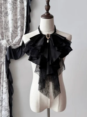 Black Gothic Lolita detachable jabot collar displayed on a mannequin, featuring layered satin-style ruffles, lace trim, and a vintage brooch with decorative pendant