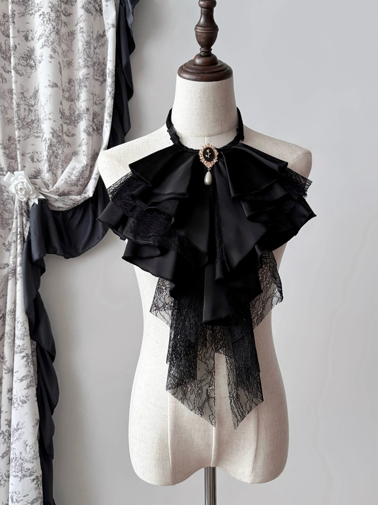 Black Gothic Lolita detachable jabot collar displayed on a mannequin, featuring layered satin-style ruffles, lace trim, and a vintage brooch with decorative pendant