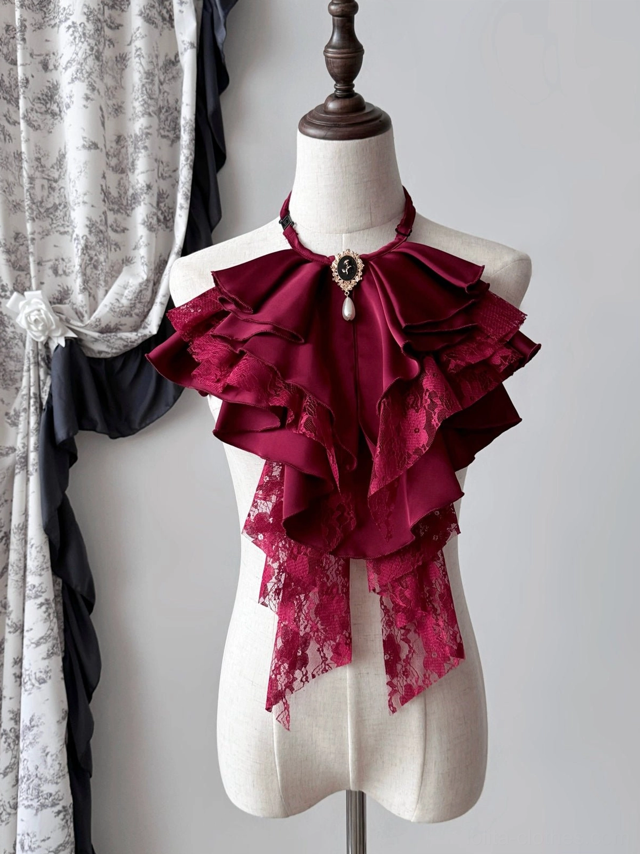 Dark red Gothic Lolita detachable jabot collar on a mannequin with cascading ribbon ruffles, lace hem, and matching vintage-style gemstone brooch