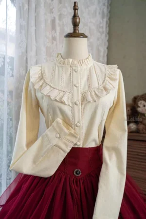 Burgundy and white daily lolita fleece blouse with ruffled stand collar and lace trim worn with matching burgundy tulle skirt on dress mannequin