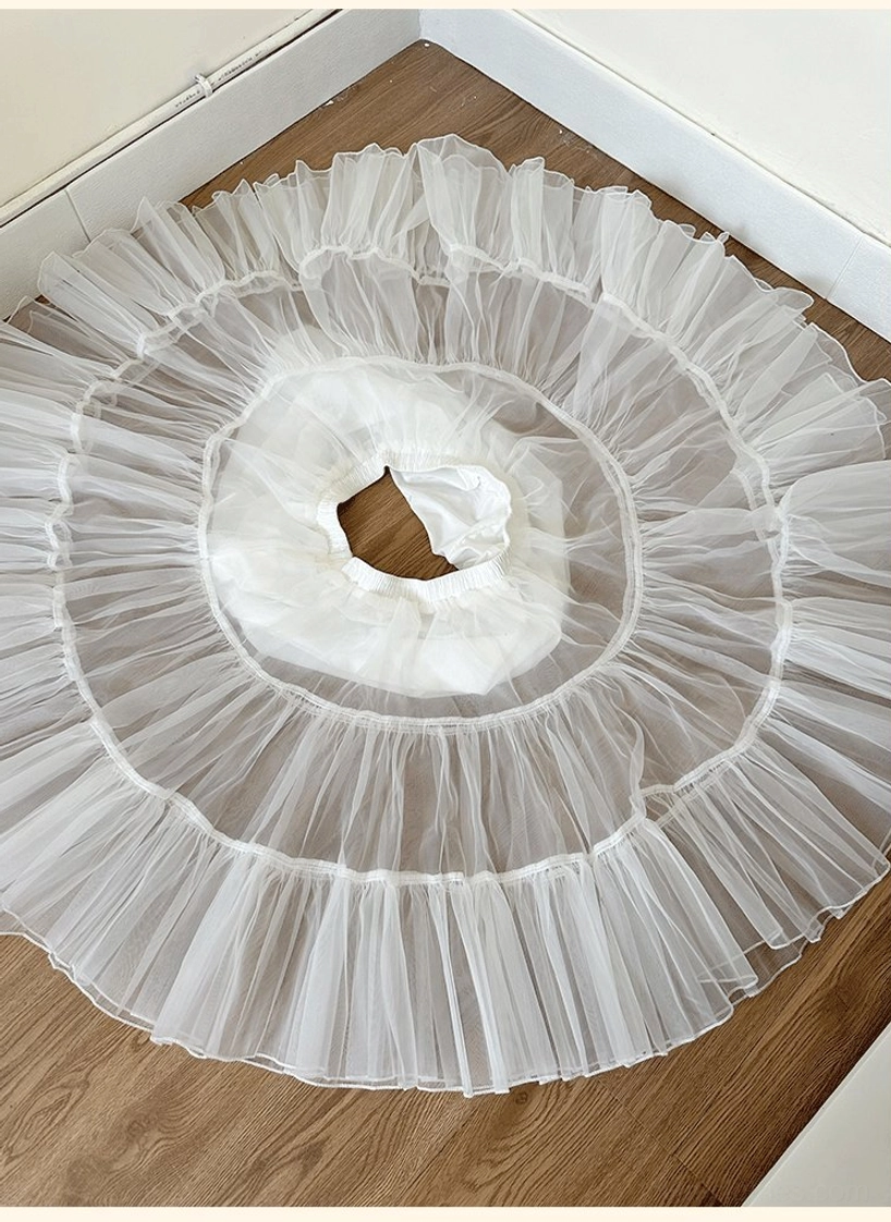 Daily lolita petticoat flat lay overhead top-down view on wooden table displaying circular tiered tulle structure and elastic waist opening
